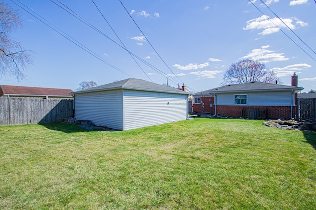view of yard featuring fence and an outbuilding
