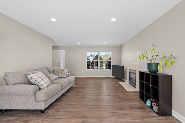living area with recessed lighting, baseboards, and wood finished floors