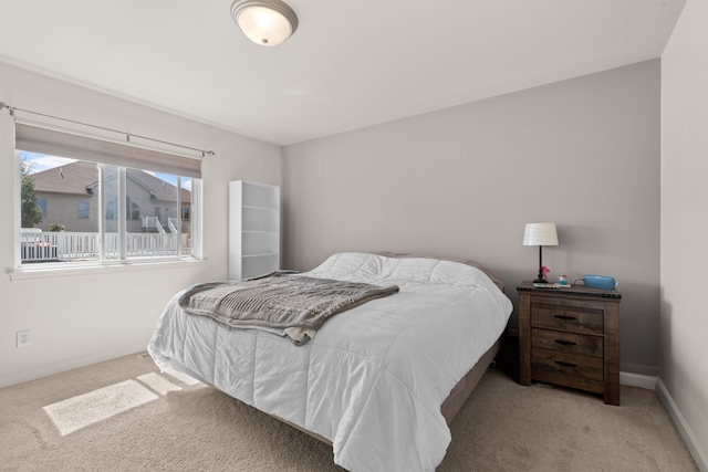 carpeted bedroom featuring baseboards