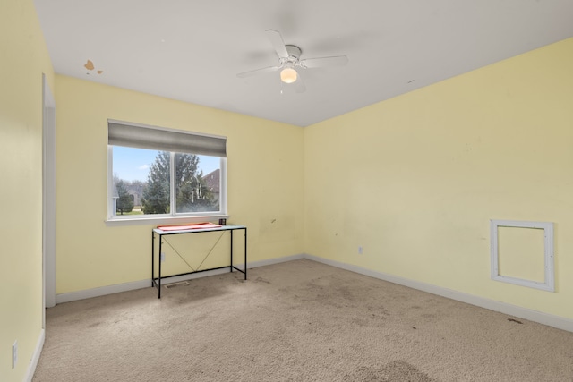 empty room featuring carpet floors, baseboards, and ceiling fan