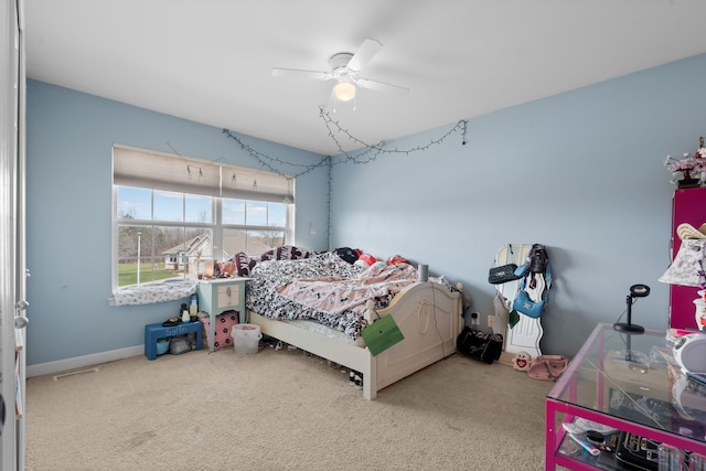 carpeted bedroom featuring ceiling fan and visible vents