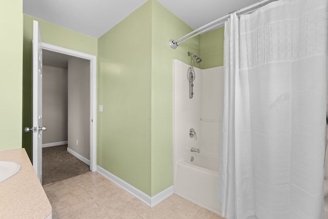 full bathroom featuring baseboards, a sink, and shower / bath combo