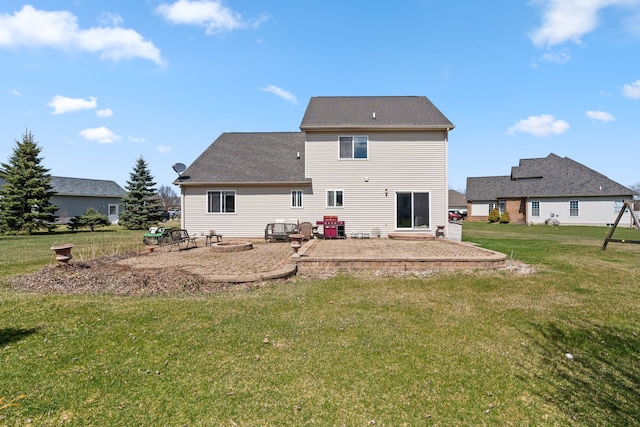 rear view of property featuring a lawn, a fire pit, and a patio area