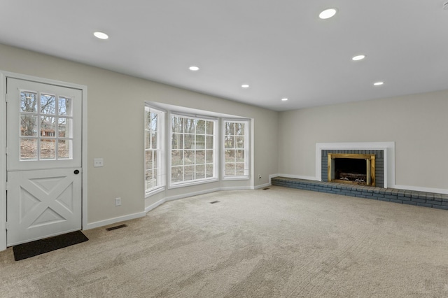 unfurnished living room featuring visible vents, baseboards, recessed lighting, and carpet