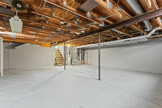 unfinished below grade area featuring stairway and gas water heater