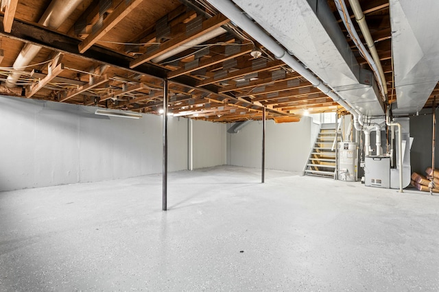unfinished basement with stairs, water heater, and heating unit