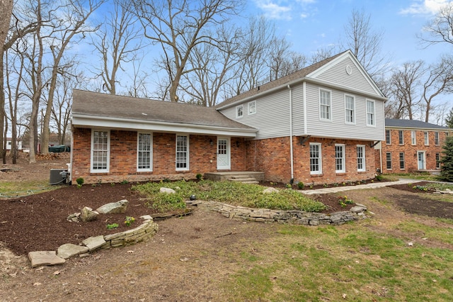 view of front of home with brick siding and cooling unit