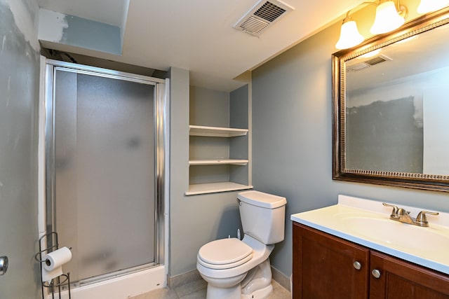 bathroom featuring a shower stall, toilet, vanity, tile patterned flooring, and baseboards