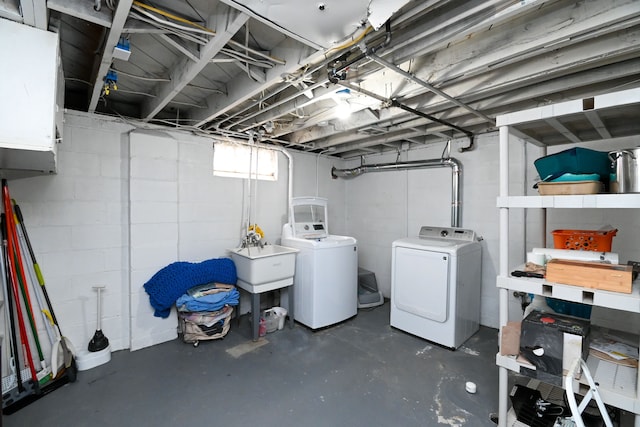 below grade area featuring separate washer and dryer and concrete block wall