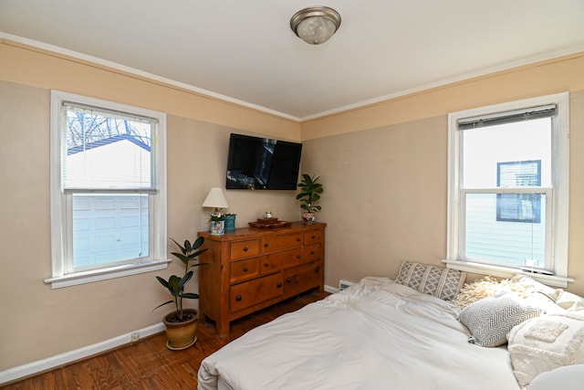 bedroom with dark wood finished floors and baseboards