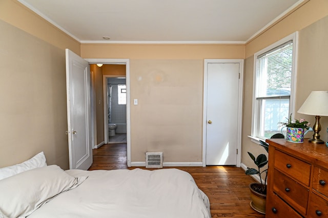 bedroom featuring dark wood-style flooring, baseboards, ornamental molding, and heating unit