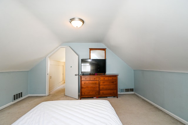 bedroom with carpet floors, lofted ceiling, and baseboards
