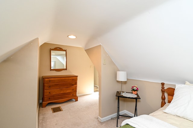 carpeted bedroom featuring vaulted ceiling and baseboards