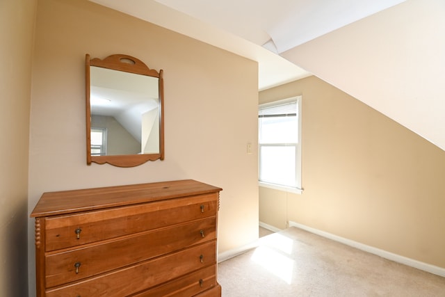 additional living space with lofted ceiling, carpet flooring, and baseboards