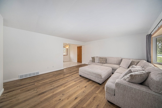 2771 Park Dr, Adrian, MI 49221 - living room with baseboards, a chandelier, hardwood / wood-style floors, and visible vents