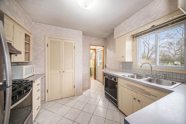 2771 Park Dr, Adrian, MI 49221 - kitchen with cream cabinets, a sink, light countertops, stainless steel appliances, and light tile patterned floors