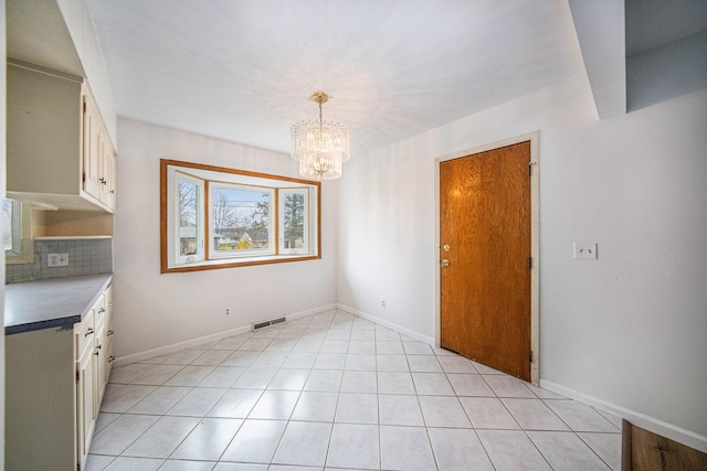 2771 Park Dr, Adrian, MI 49221 - unfurnished dining area with plenty of natural light, baseboards, visible vents, and an inviting chandelier
