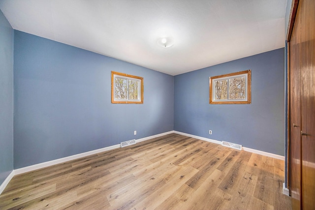 2771 Park Dr, Adrian, MI 49221 - spare room featuring baseboards, wood finished floors, and visible vents