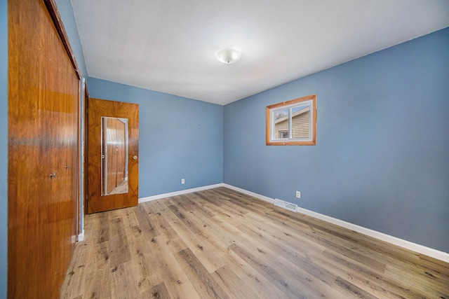 2771 Park Dr, Adrian, MI 49221 - empty room featuring baseboards, visible vents, and wood finished floors