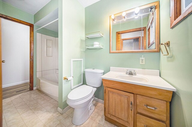 2771 Park Dr, Adrian, MI 49221 - full bathroom featuring vanity, washtub / shower combination, baseboards, and toilet
