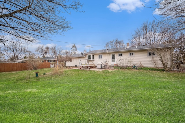 2771 Park Dr, Adrian, MI 49221 - back of property featuring a patio, fence, a yard, and a chimney