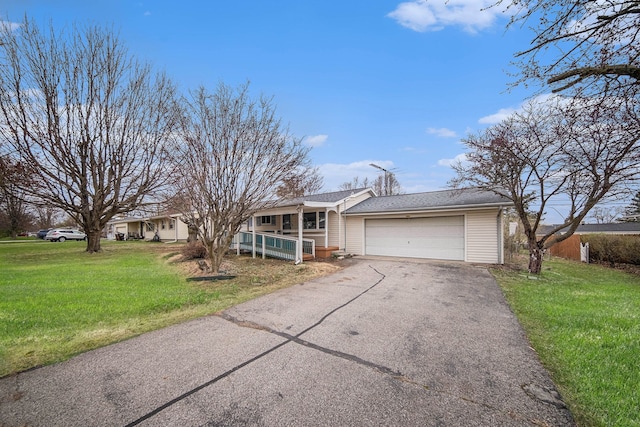2771 Park Dr, Adrian, MI 49221 - view of front facade featuring covered porch, driveway, a garage, a front lawn, and a shingled roof