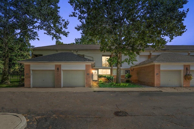 view of front of property featuring an attached garage and brick siding