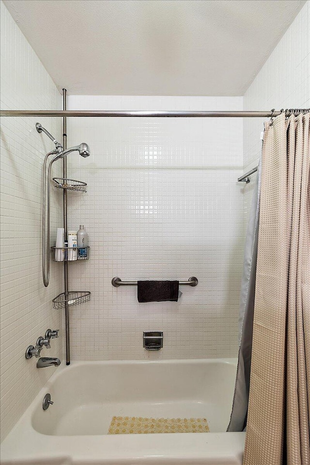bathroom featuring shower / tub combo with curtain