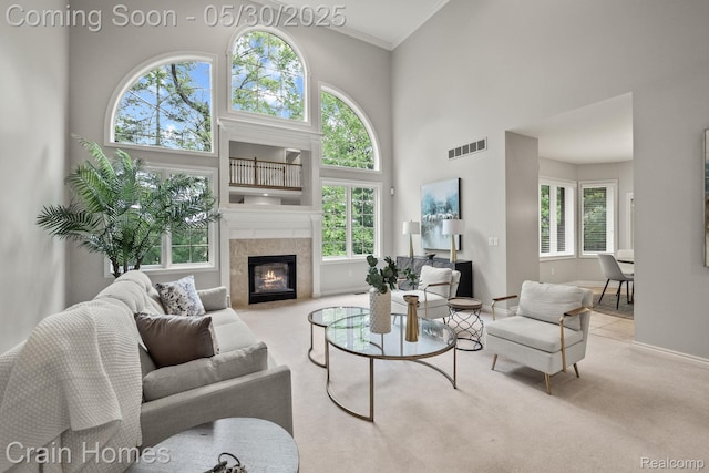 1171 Deer Path Trl, Oxford, MI 48371 - living room featuring carpet, a high ceiling, crown molding, baseboards, and a tiled fireplace
