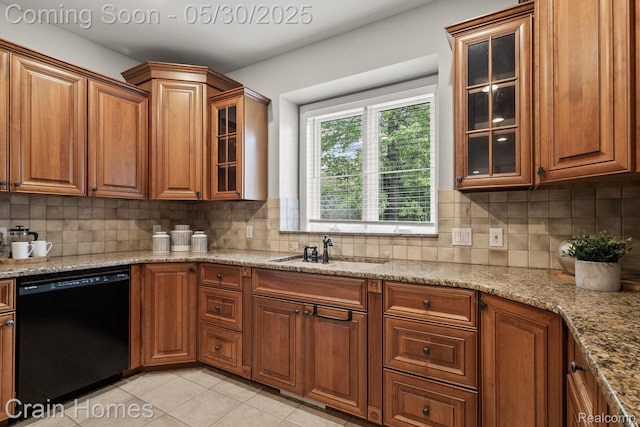 1171 Deer Path Trl, Oxford, MI 48371 - kitchen featuring dishwasher, a sink, brown cabinets, and tasteful backsplash