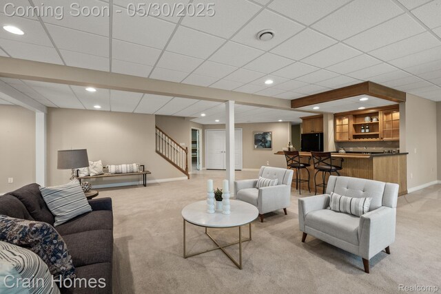 1171 Deer Path Trl, Oxford, MI 48371 - living area with light colored carpet, wet bar, stairs, baseboards, and recessed lighting