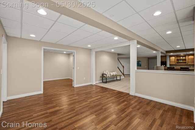 1171 Deer Path Trl, Oxford, MI 48371 - unfurnished living room featuring wood finished floors, stairway, a paneled ceiling, baseboards, and recessed lighting