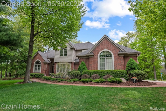 1171 Deer Path Trl, Oxford, MI 48371 - traditional-style house featuring brick siding, a front lawn, and a shingled roof