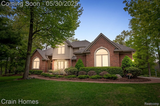 1171 Deer Path Trl, Oxford, MI 48371 - view of front of home featuring brick siding, a front lawn, and roof with shingles
