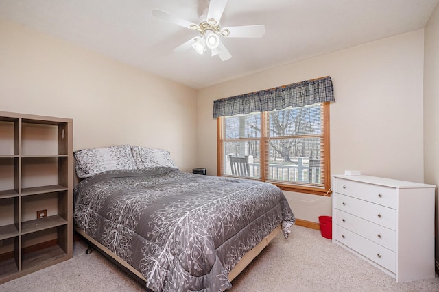 carpeted bedroom with a ceiling fan and baseboards