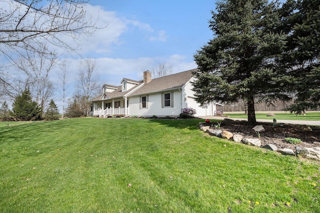 back of property featuring a chimney, a shingled roof, an attached garage, a lawn, and a porch