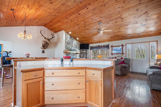 kitchen featuring vaulted ceiling, light countertops, wood ceiling, hardwood / wood-style floors, and open floor plan