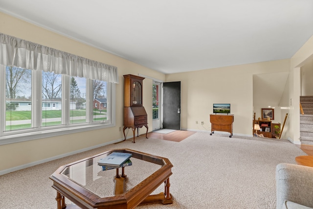 living room featuring stairway, carpet, and baseboards