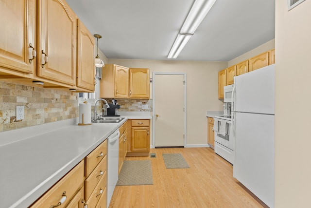 kitchen featuring a sink, visible vents, light brown cabinets, light wood-type flooring, and white appliances