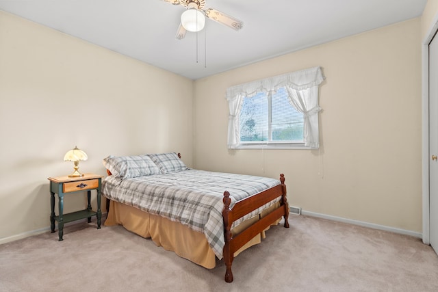 bedroom featuring ceiling fan, light carpet, and baseboards