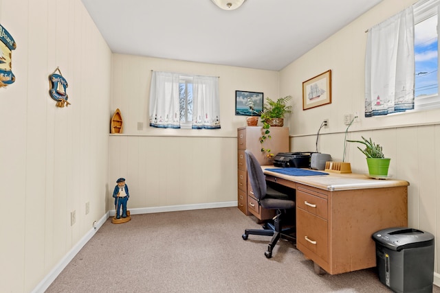 office with baseboards and light carpet