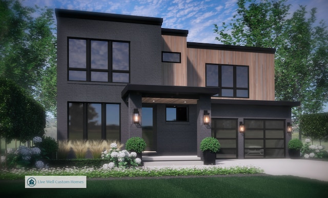 contemporary house featuring a garage, brick siding, and driveway