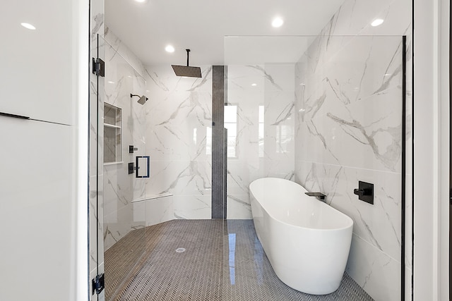 full bathroom featuring tile walls, a marble finish shower, recessed lighting, and a freestanding bath