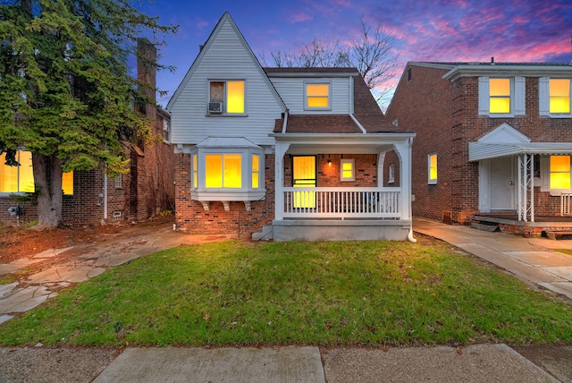 16171 Ilene St, Detroit, MI 48221 - bungalow-style home with brick siding, a porch, and a front lawn
