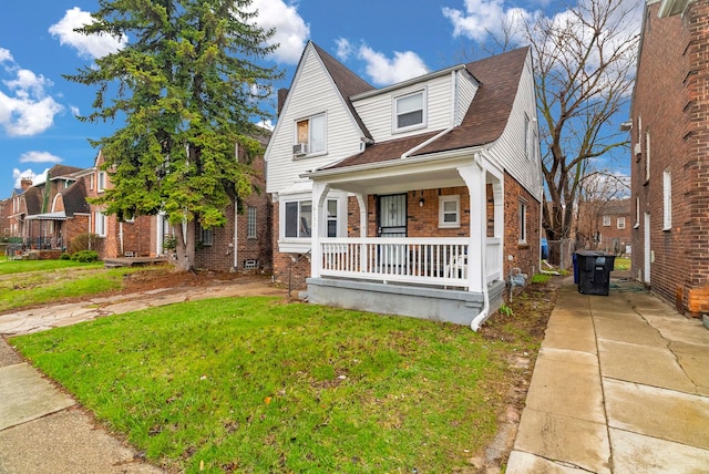 16171 Ilene St, Detroit, MI 48221 - view of front of home featuring a residential view, a front lawn, brick siding, a shingled roof, and covered porch