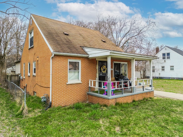 19965 Barlow St, Detroit, MI 48205 - rear view of property featuring roof with shingles, a lawn, fence, and brick siding