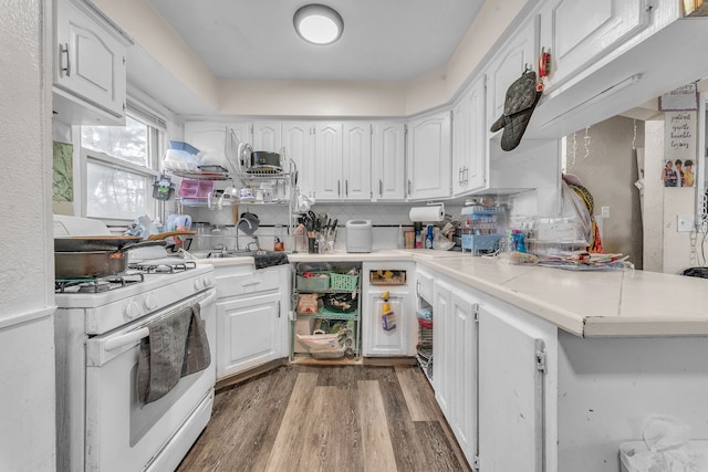 19965 Barlow St, Detroit, MI 48205 - kitchen with white cabinetry, wood finished floors, light countertops, and white gas range
