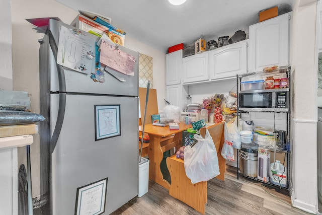 19965 Barlow St, Detroit, MI 48205 - kitchen with white cabinets, light wood-style floors, and stainless steel appliances