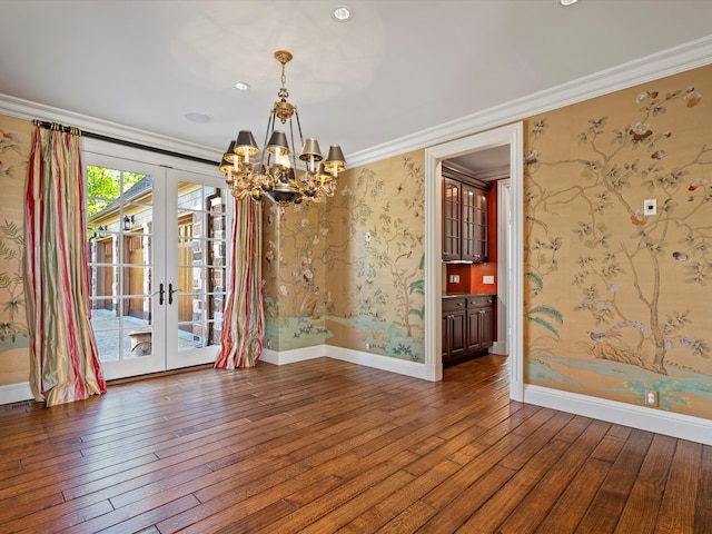 unfurnished dining area featuring a chandelier, baseboards, french doors, and wood-type flooring