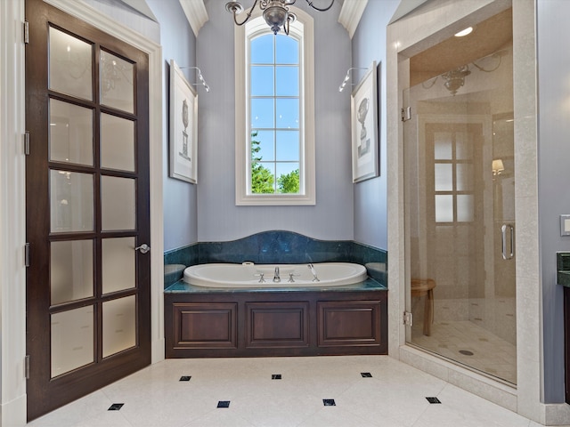 bathroom with tile patterned floors, a shower stall, a garden tub, and crown molding